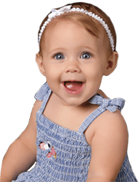 Baby girl with pony tail in white